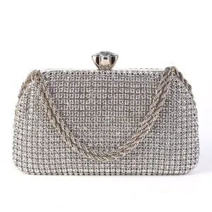 Sparkling rhinestone evening clutch bag detail, elegant crystal clasp and metallic chain strap.