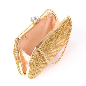 Gold rhinestone evening bag crystal clasp detail showing sparkling diamonds and chain strap close up