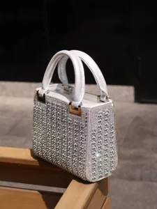 Exquisite rhinestone evening handbag with structured design and metallic hardware details.