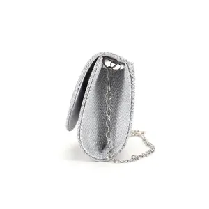 Side detail view of the sparkling silver glitter evening clutch bag with metal chain strap.