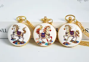 Detailed shot of exquisite gold pocket watch featuring traditional Chinese horse design and chain.