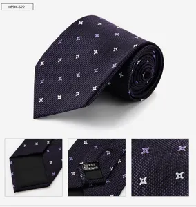 Detail view of a luxury silk business tie with elegant geometric pattern for men formal wear.