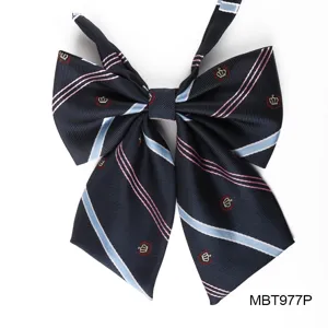 Navy blue JK uniform bow tie with pink and blue stripes, embroidered crown detail, detail view