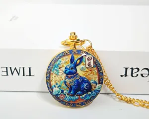 Detailed close-up of the golden Chinese zodiac rabbit pocket watch necklace with exquisite blue design.