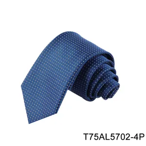 Detailed view of rolled blue men's business tie with geometric jacquard dot pattern.
