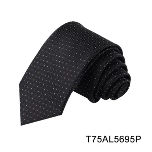 Black jacquard tie detail showing geometric dot pattern and smooth fabric texture for business wear.