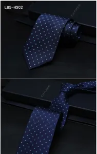 Close-up detail of luxury dark blue silk jacquard tie with elegant geometric pattern.