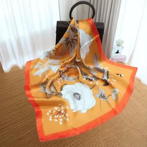 Luxury silk square scarf for women with elegant floral print and vibrant orange border design.