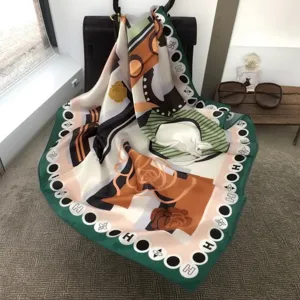 Silk square scarf detail view featuring elegant equestrian print and signature H border design.