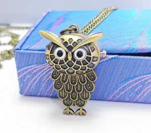 Vintage bronze owl pocket watch necklace detail view, exquisite animal design and texture.