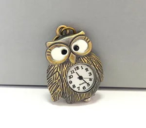 Antique bronze owl pocket watch detail view with vintage quartz dial and cute design.