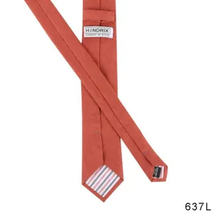 Detail view of a Japanese casual men's cotton linen solid color necktie in terracotta red.