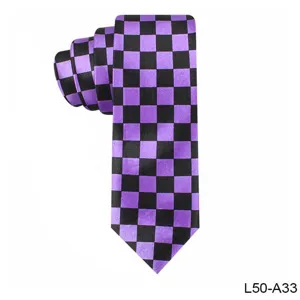Purple and black checkerboard pattern necktie detail shot, showing fine fabric and neat fold.