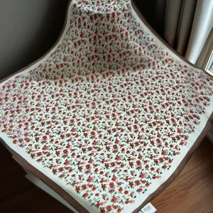 Silk square scarf for women, elegant red rose floral print with brown border accessory.