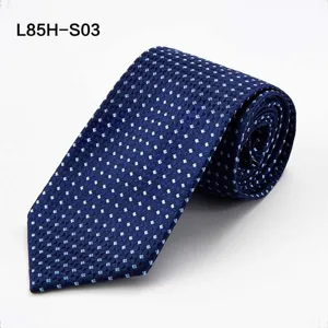 Detailed closeup of the rolled blue business tie featuring subtle geometric square patterns.