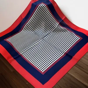 Close-up detail of the luxury silk square scarf featuring classic red, blue and white stripes.
