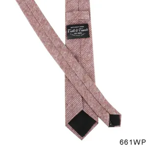 Detailed view of the red-brown tweed men's necktie showing the brand heritage label.