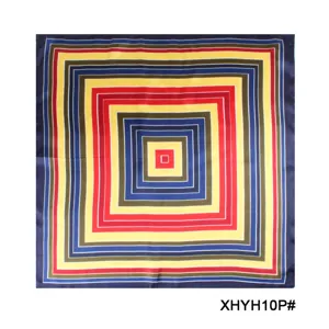 Detail shot of a geometric printed silk square scarf, featuring vibrant concentric square patterns.