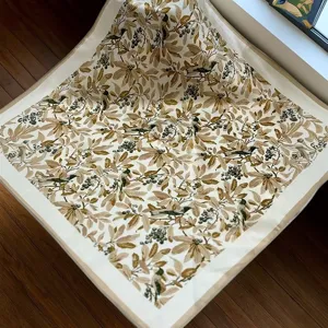Detailed view of the vintage botanical print silk square scarf showing exquisite bird motif.