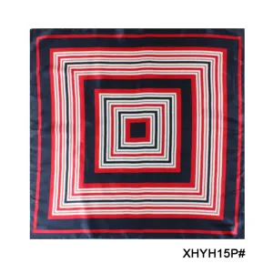 Detailed shot of a geometric square silk scarf with red, black, and white patterns.