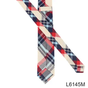 Detailed view of a classic plaid skinny tie with red, navy and beige tartan pattern for men.