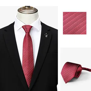 Red silk texture business necktie detail shot showing fabric weave and rolled form