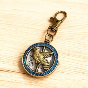 Vintage bronze bird pocket watch keychain with blue glitter bezel and quartz dial.