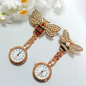 Detailed view of alloy bee nurse pocket watch with crystal rhinestones and pearls, fashion quartz.
