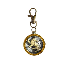 Vintage brass pocket watch keychain with glitter bezel and cute climbing bear dial design.