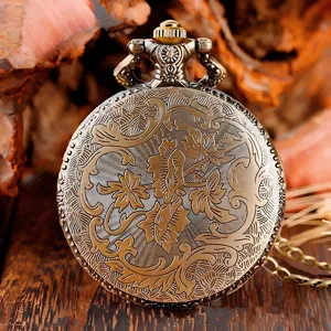 Vintage quartz pocket watch detail view showcasing intricate floral scroll engraving back.