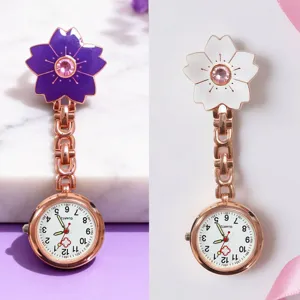 Detailed view of exquisite cherry blossom nurse watch with quartz movement and metallic chain.