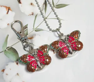 Detailed view of the gradient butterfly pocket watch and keychain pendant with vibrant enamel.