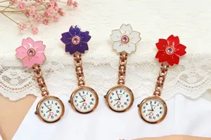 Detail view of colorful cherry blossom nurse pocket watch with rose gold chain and quartz dial.