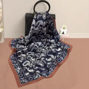 Detailed view of luxury mulberry silk square scarf with classic paisley print in dark blue.