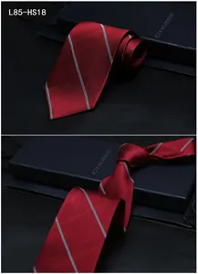 Detailed view of red silk jacquard tie with stripe pattern, elegant business accessory.