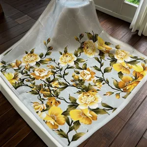 Luxurious mulberry silk square scarf with elegant yellow floral print and grey background.