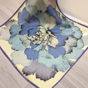 Elegant mulberry silk square scarf with vibrant blue floral print, soft and versatile for women.