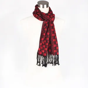 Detailed view of red and black jacquard pattern winter scarf with stylish black tassels.
