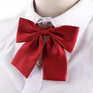 Close-up detail of a glossy red JK uniform bow tie, perfect for student and college styles.