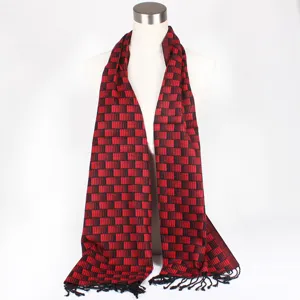 Details of the red and black silk jacquard scarf featuring elegant fringes and pattern.