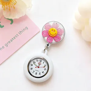 Silicone nurse watch detail view featuring pink glitter flower and cute yellow smiley clip.