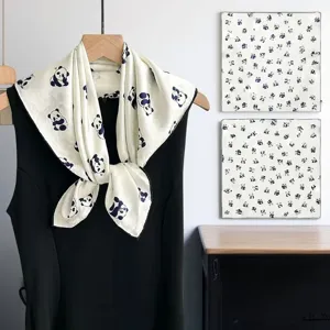 Detailed view of the mulberry silk square scarf featuring elegant blue panda prints on white.