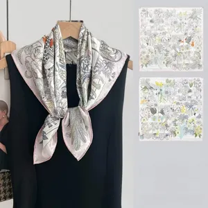 Detailed view of luxury printed silk square scarf with intricate botanical jungle motifs.