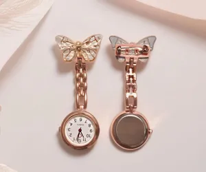 Detailed view of rose gold nurse pocket watch featuring crystal butterfly and quartz dial.