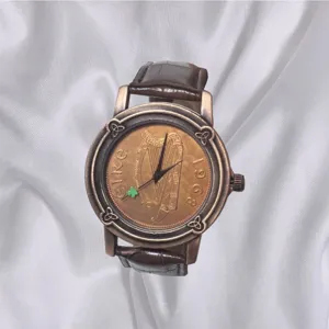 Vintage embossed coin dial men's watch with brown leather strap and elegant retro style.