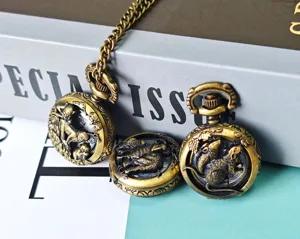 Detail shot of vintage bronze Chinese zodiac hollow carved pocket watches with chain accessory.