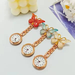 Detailed view of gradient butterfly nurse pocket watch with rose gold chain and quartz movement.