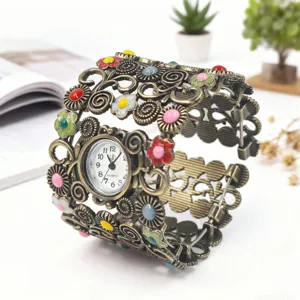 Vintage bronze metal cuff watch featuring hollow floral design with colorful enamel details.