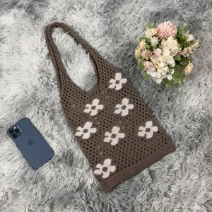 Brown crochet tote bag detail showcasing knitted floral pattern and soft texture for daily wear.
