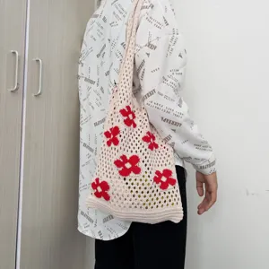Woven knitted mesh tote shoulder bag showcasing a stylish red floral pattern in detailed view